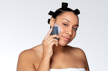 two models using charcoal bar on skin