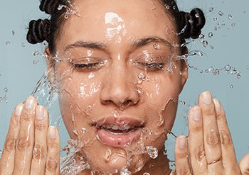 model splashing water over face