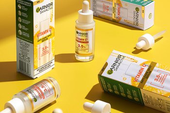 Vitamin C products on yellow background